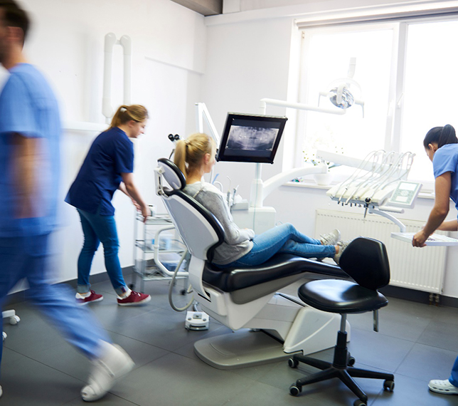 Blurred dentists treating a patient’s dental emergency