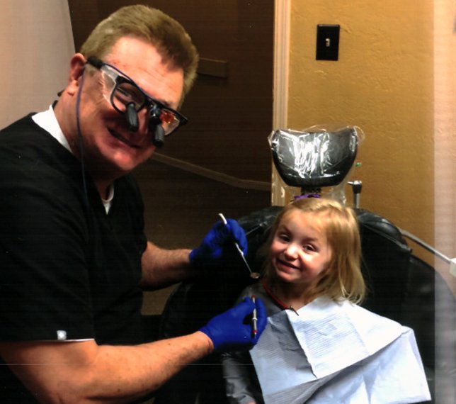 Doctor smith treating young dental patient
