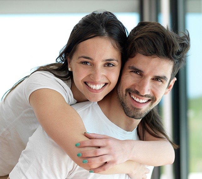 Man and woman smiling after preventive dentistry checkups