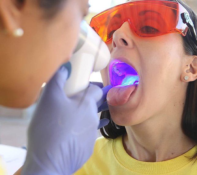 Dentist performing an oral cancer screening