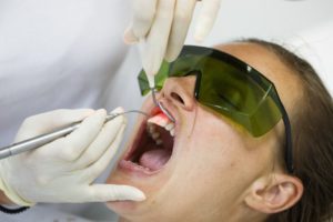 a dentist conducting laser gum recontouring