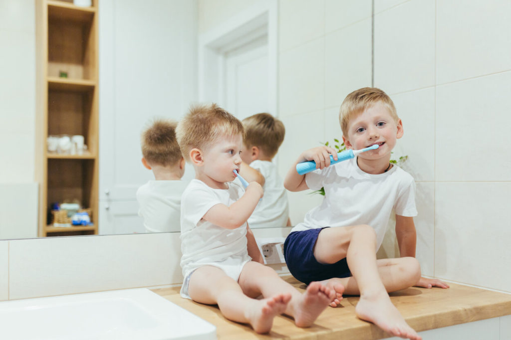children using electric toothbrushes for kids