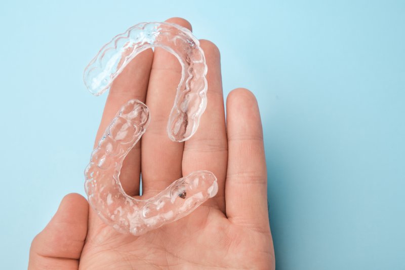 person holding aligners for ClearCorrect in Edmond